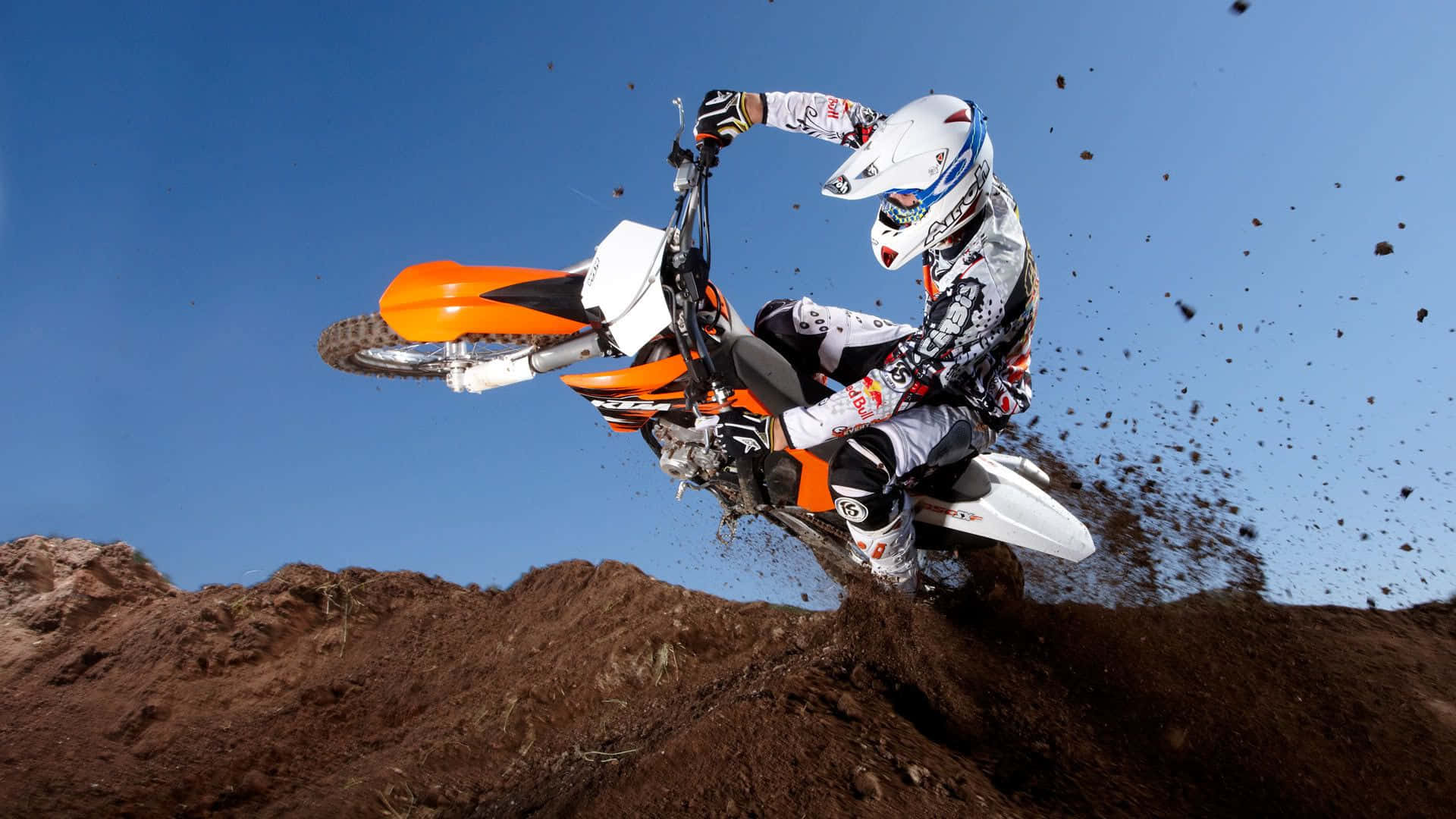 Dirtbike rider tackling a dirt trail at high speed