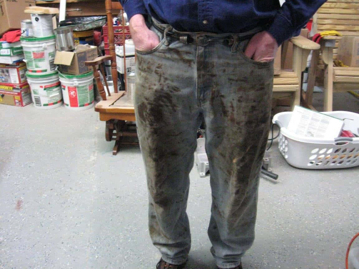 a man standing in a room with a dirty pair of pants