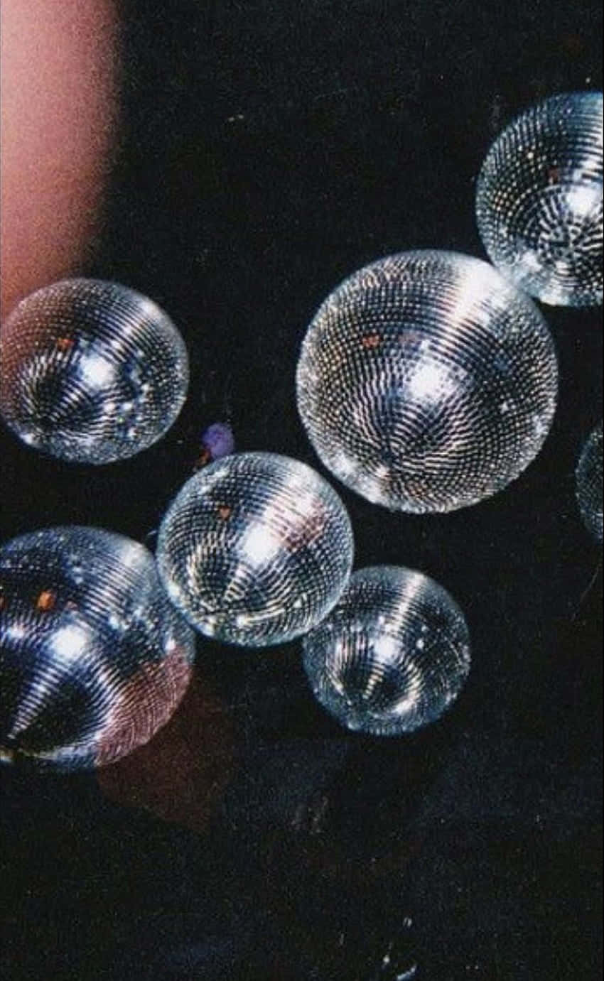 Disco Balls Floating In Darkness Wallpaper