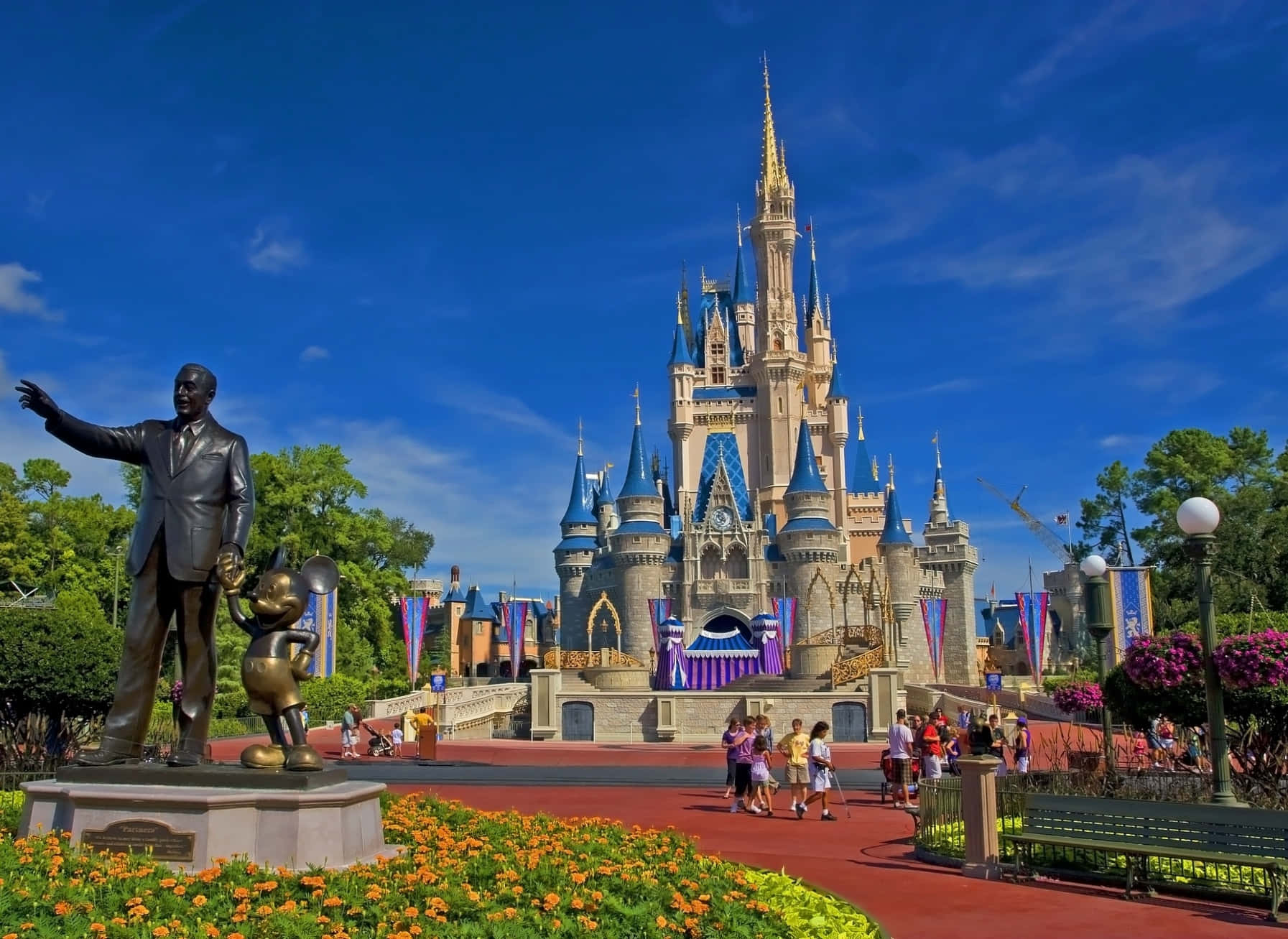 A Statue Of Cinderella And A Statue Of Walt Disney