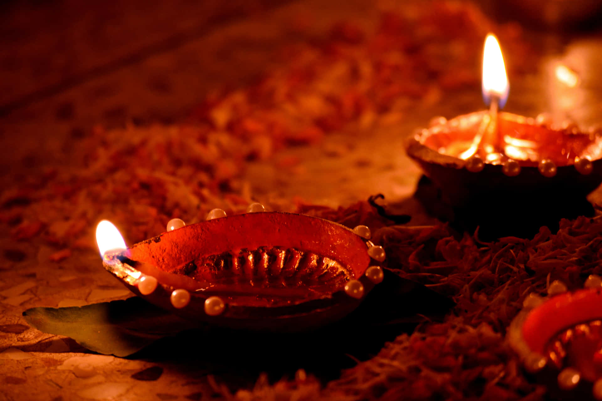 Lighted Candles On Diyas With Beads Diwali Background