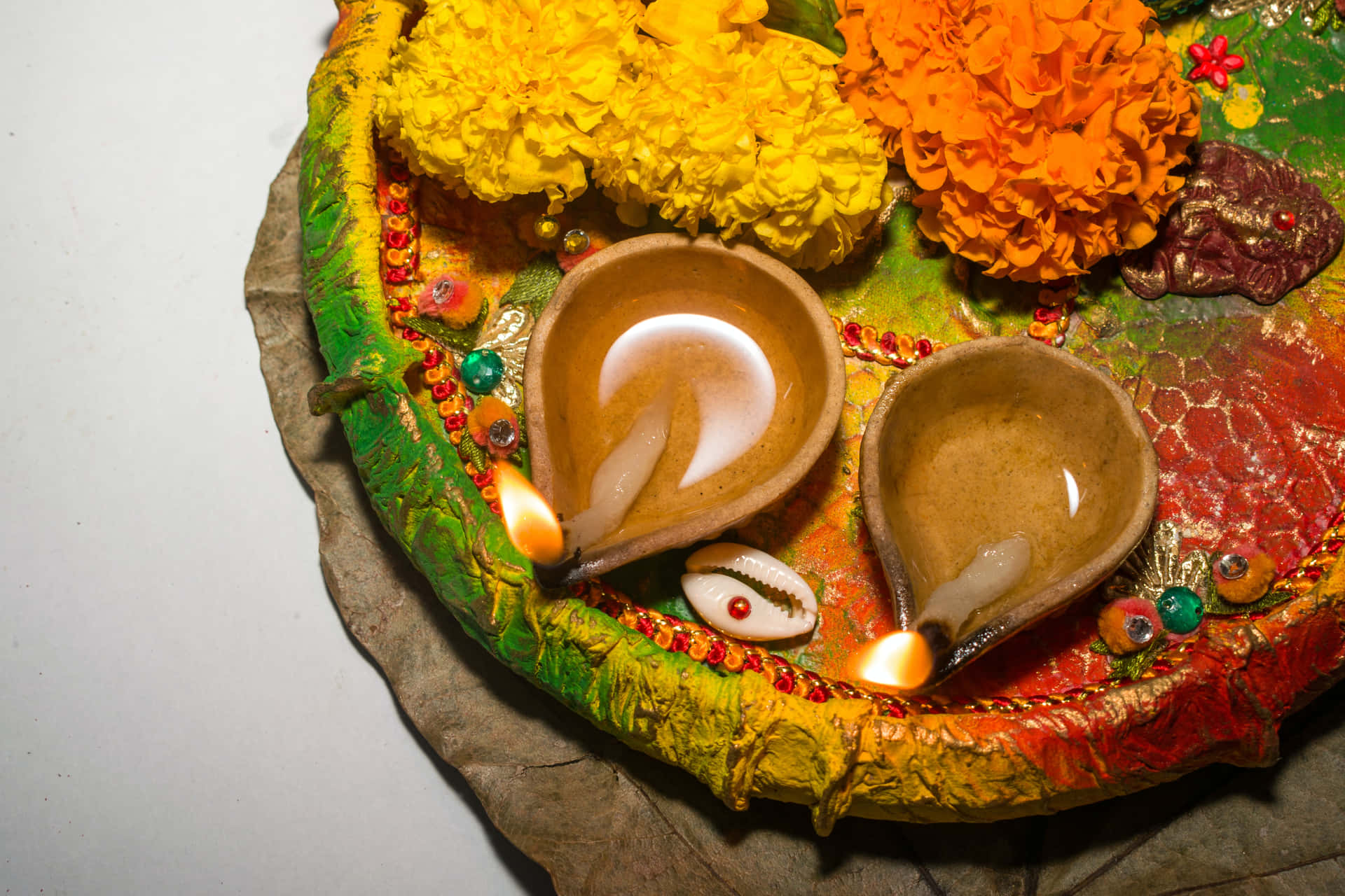 Diya Candles And Flowers On Tray Diwali Background