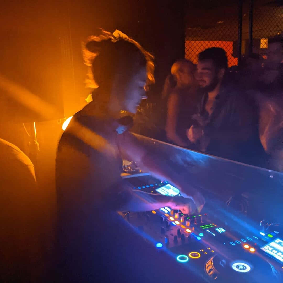 Captivating DJ in action behind lighted decks