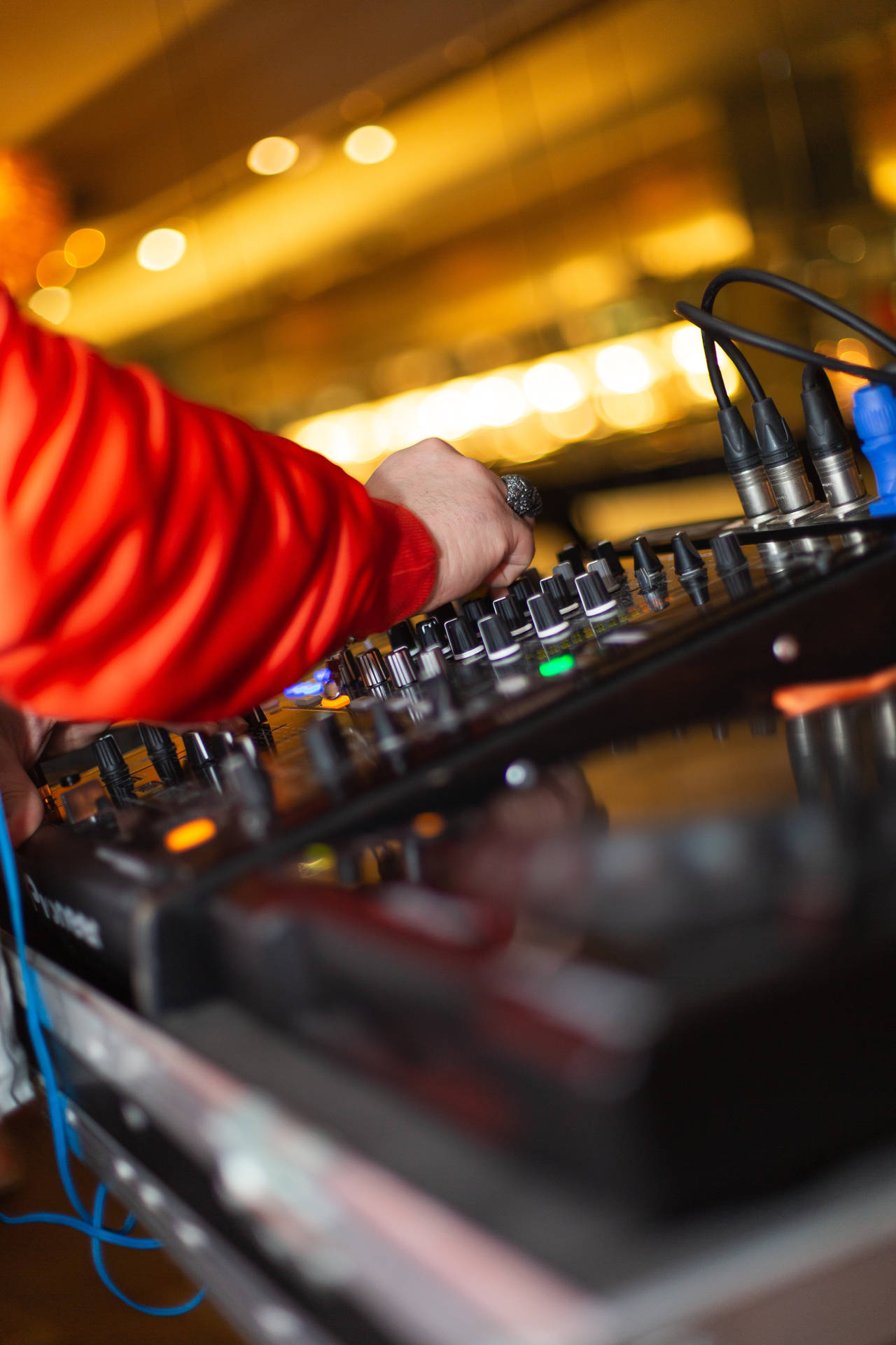 DJ skillfully mixing tunes on advanced equipment Wallpaper