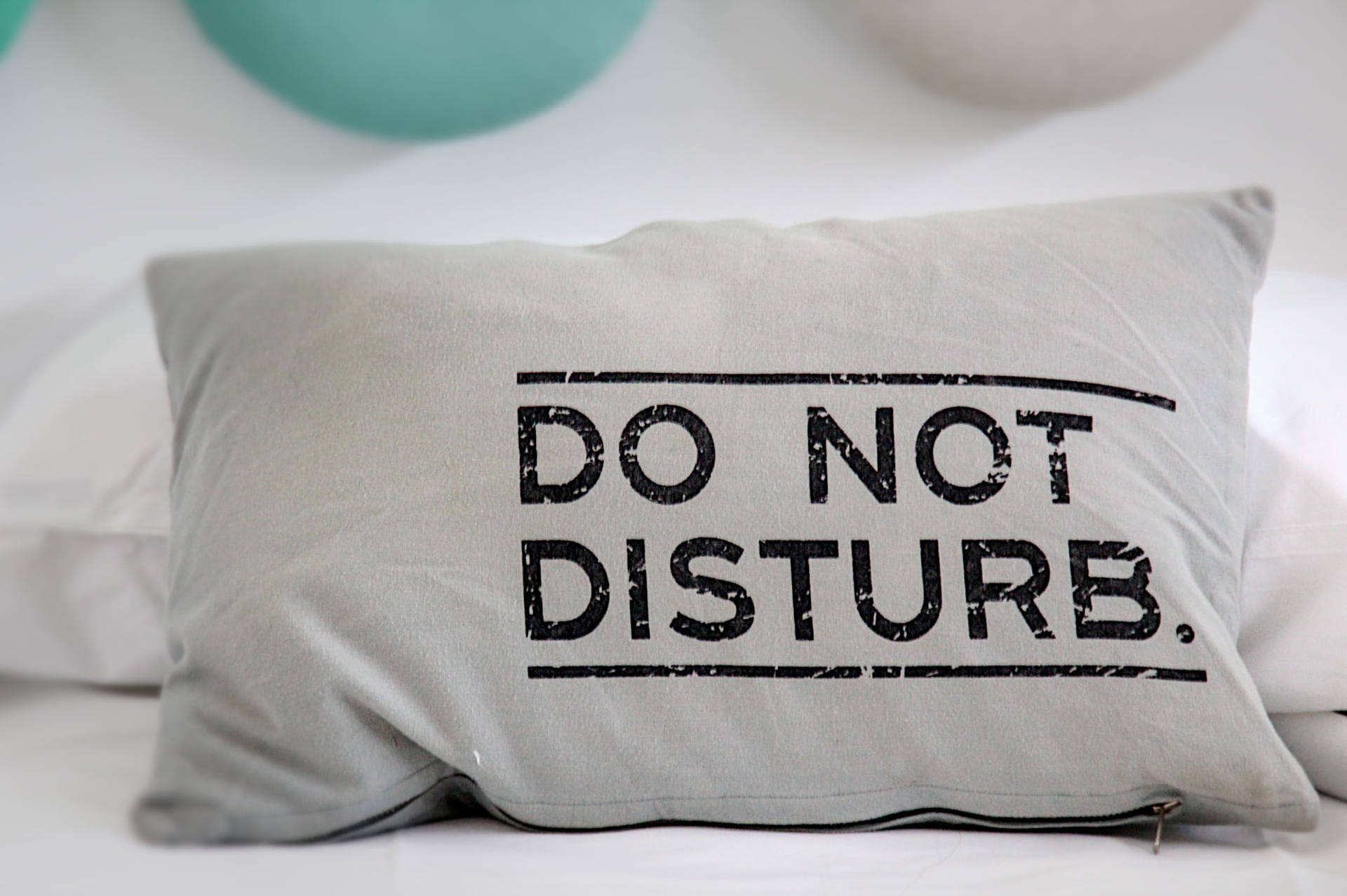 Caption: "comforting 'do Not Disturb' Pillow On Bed" Wallpaper