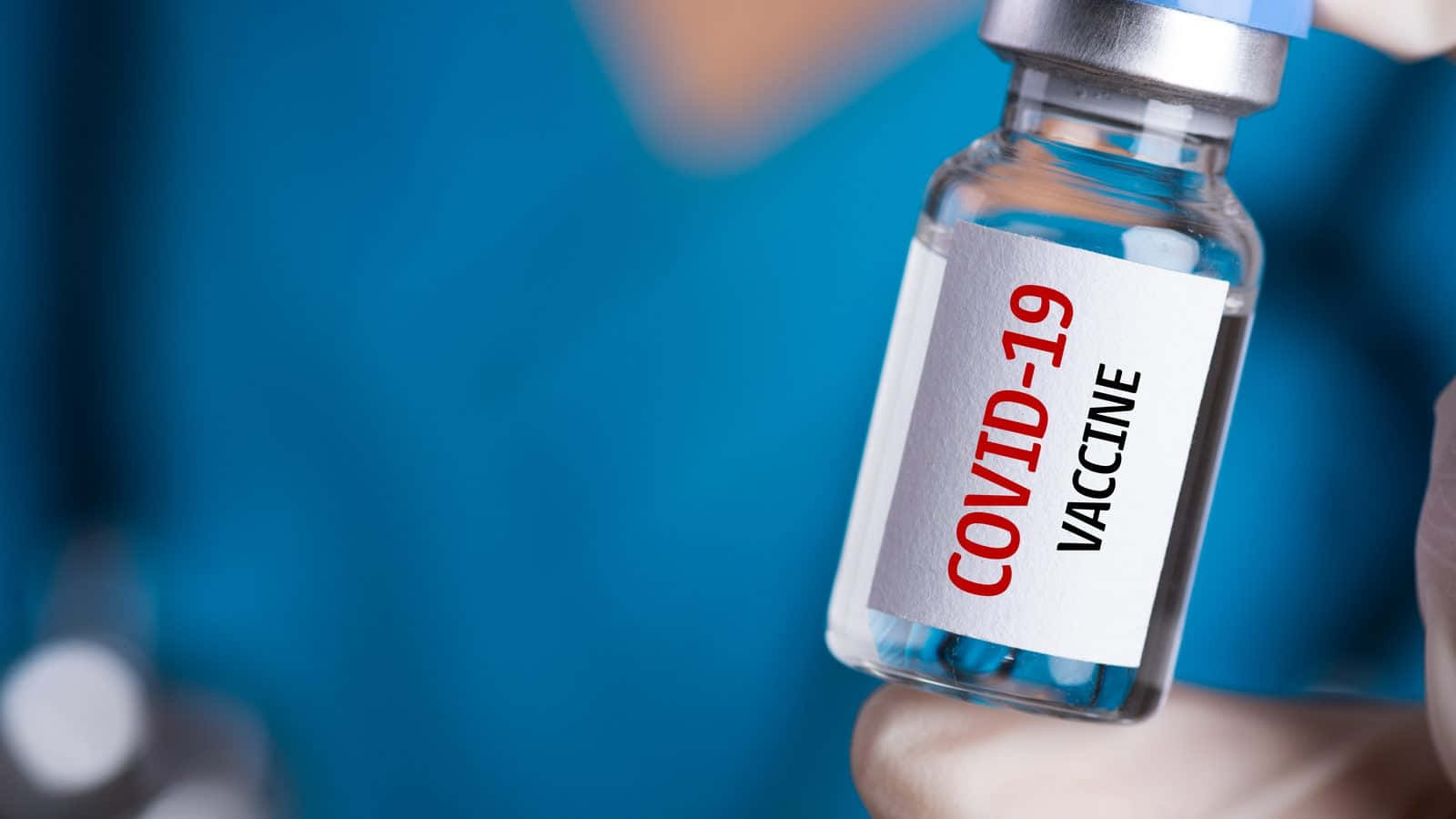 Doctor Holding Covid-19 Vaccine Vial Close-up Background