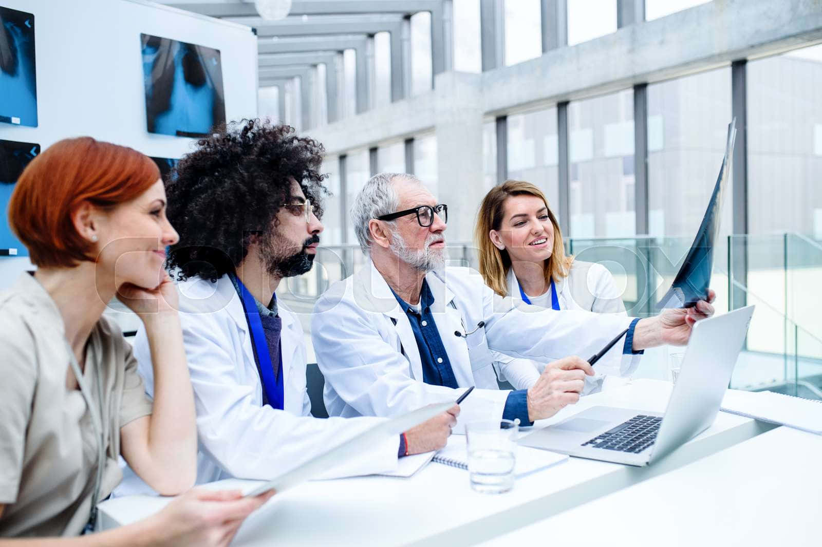 Group Of Doctors Looking At A X - Ray Stock Photo