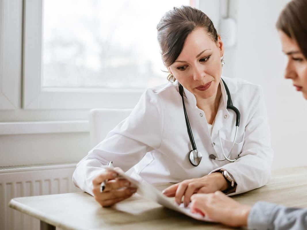 A Female Doctor Is Talking To A Female Patient