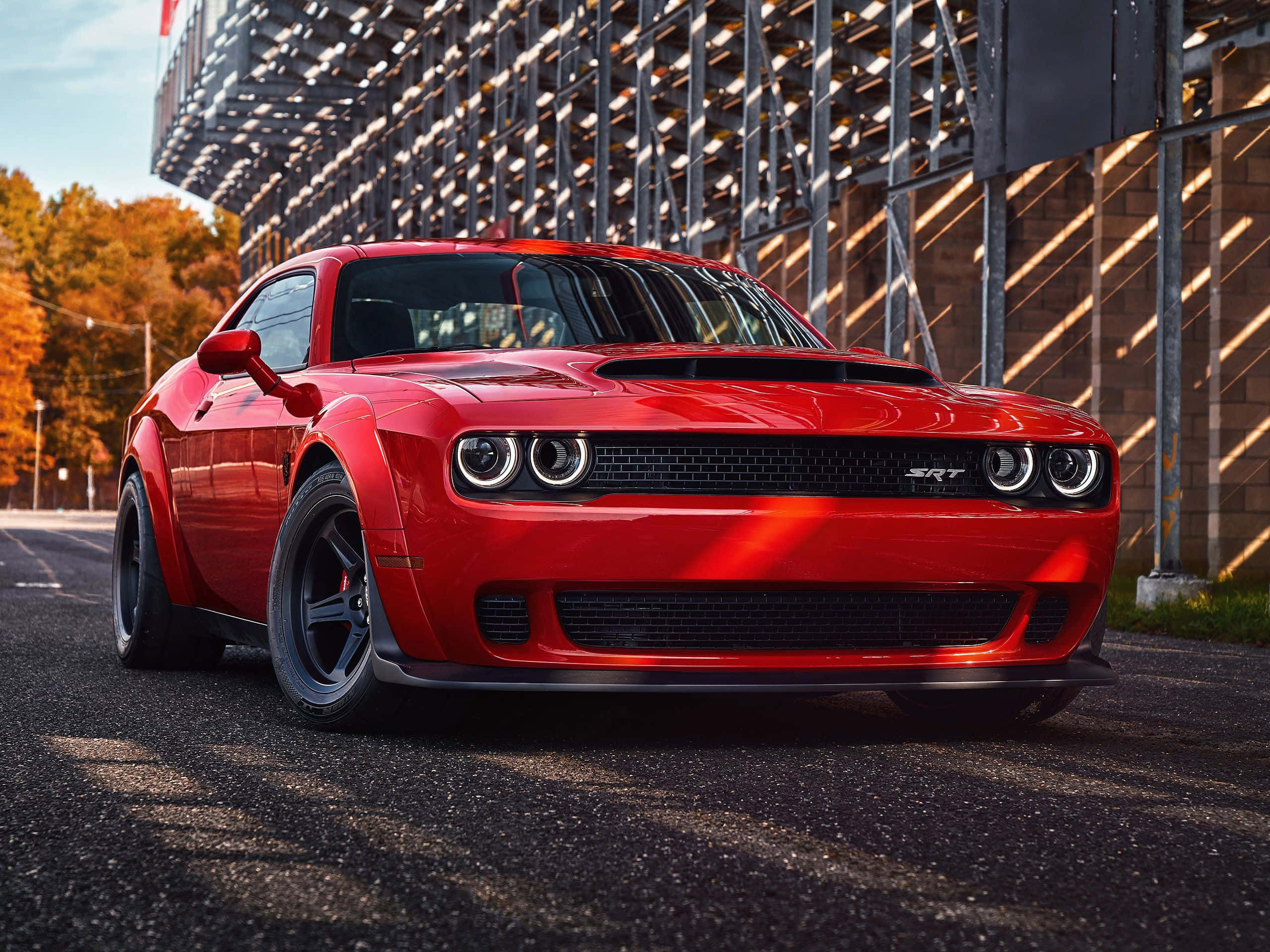 A Red Dodge Challenger Parked On A Street Wallpaper