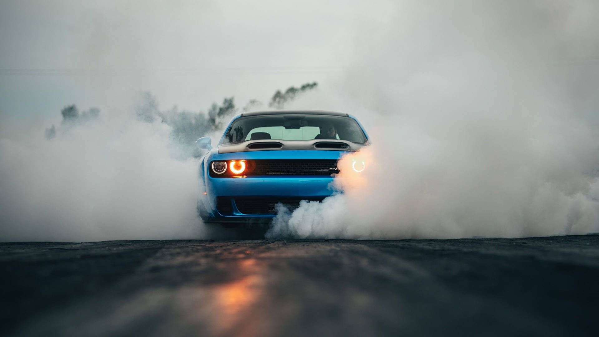 Power Unleashed - Dodge Challenger Erupting from Smoke Wallpaper