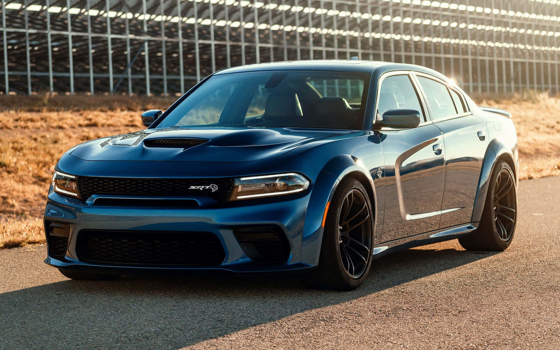Sleek and Powerful Dodge Charger on the open road Wallpaper