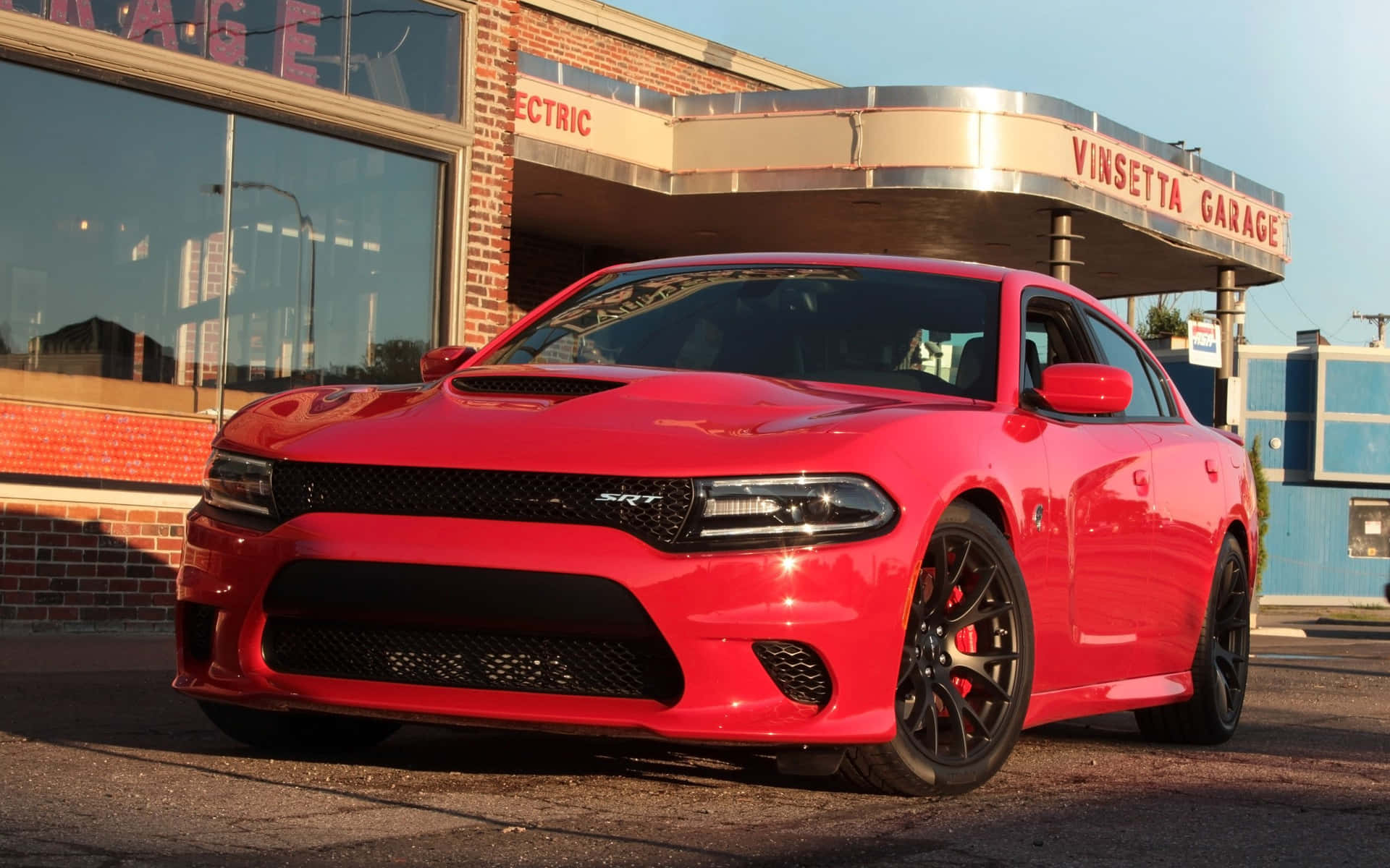 Powerful Dodge Charger Speeding Down the Road Wallpaper
