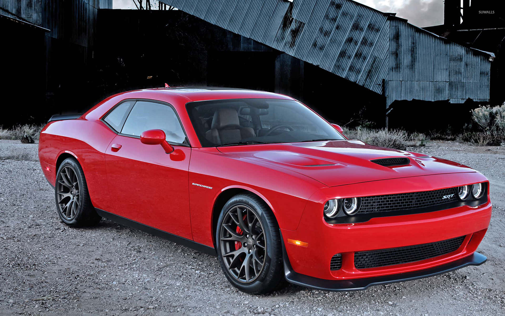 The Red Dodge Challenger Srt Parked In Front Of An Old Building Wallpaper