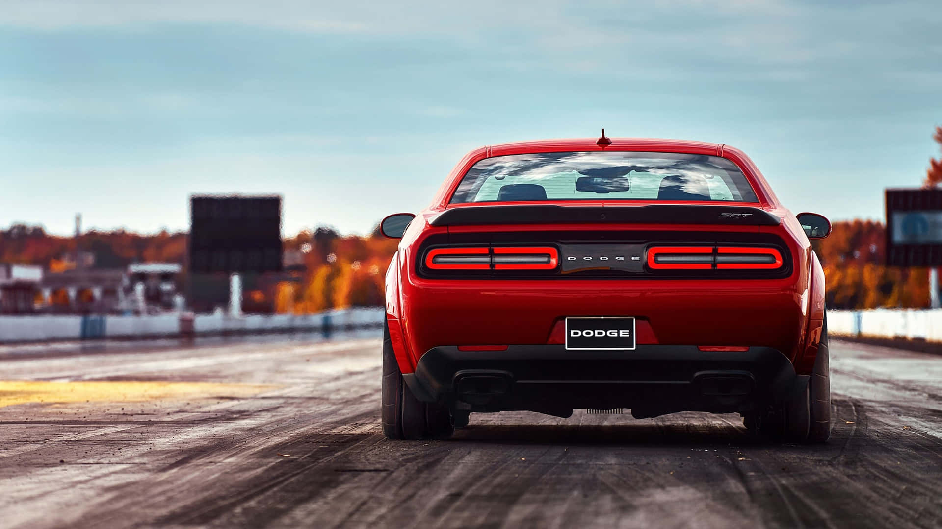 The Rear End Of A Red Dodge Challenger Wallpaper