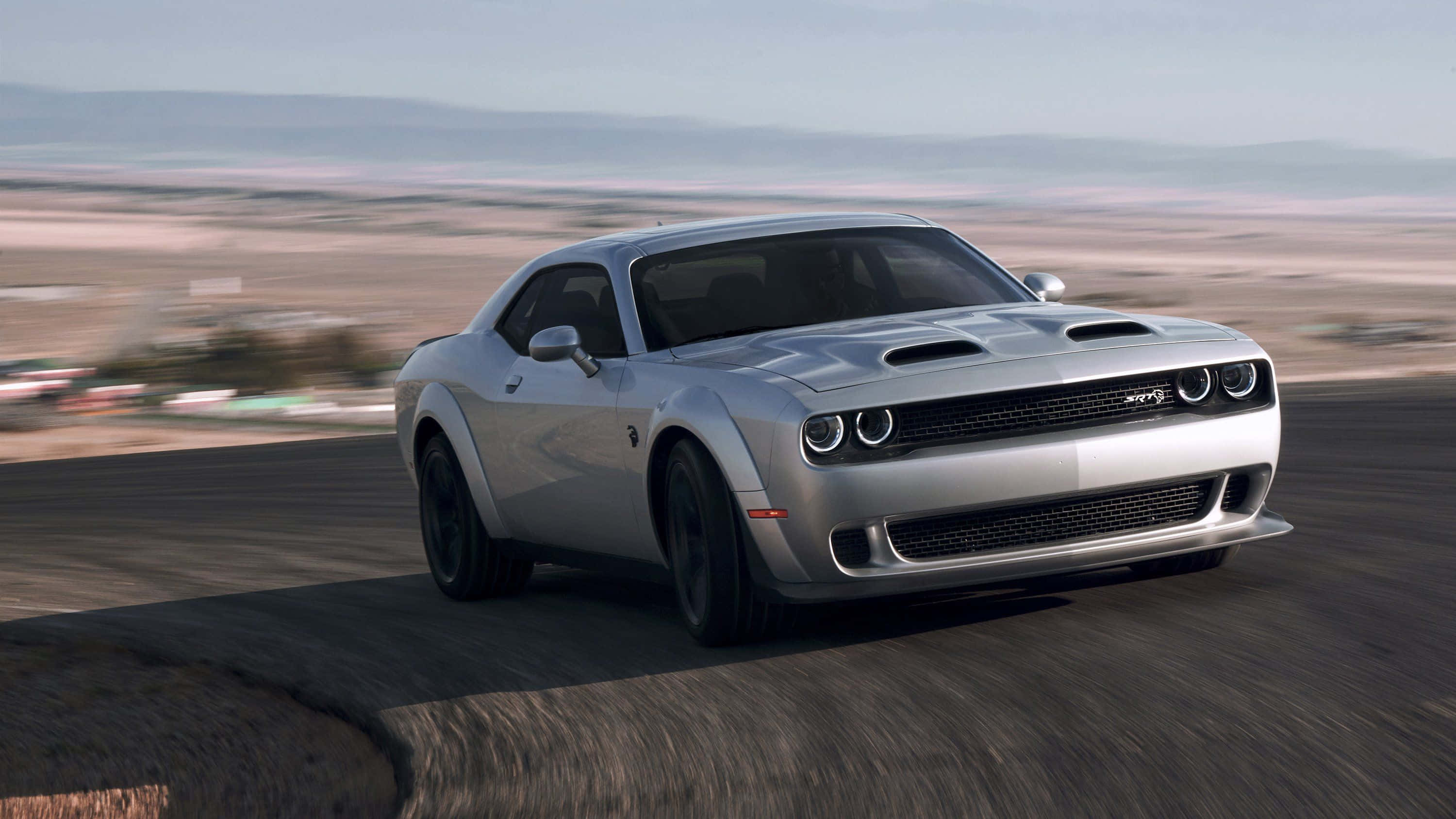 The 2020 Dodge Challenger Is Driving On A Road Wallpaper
