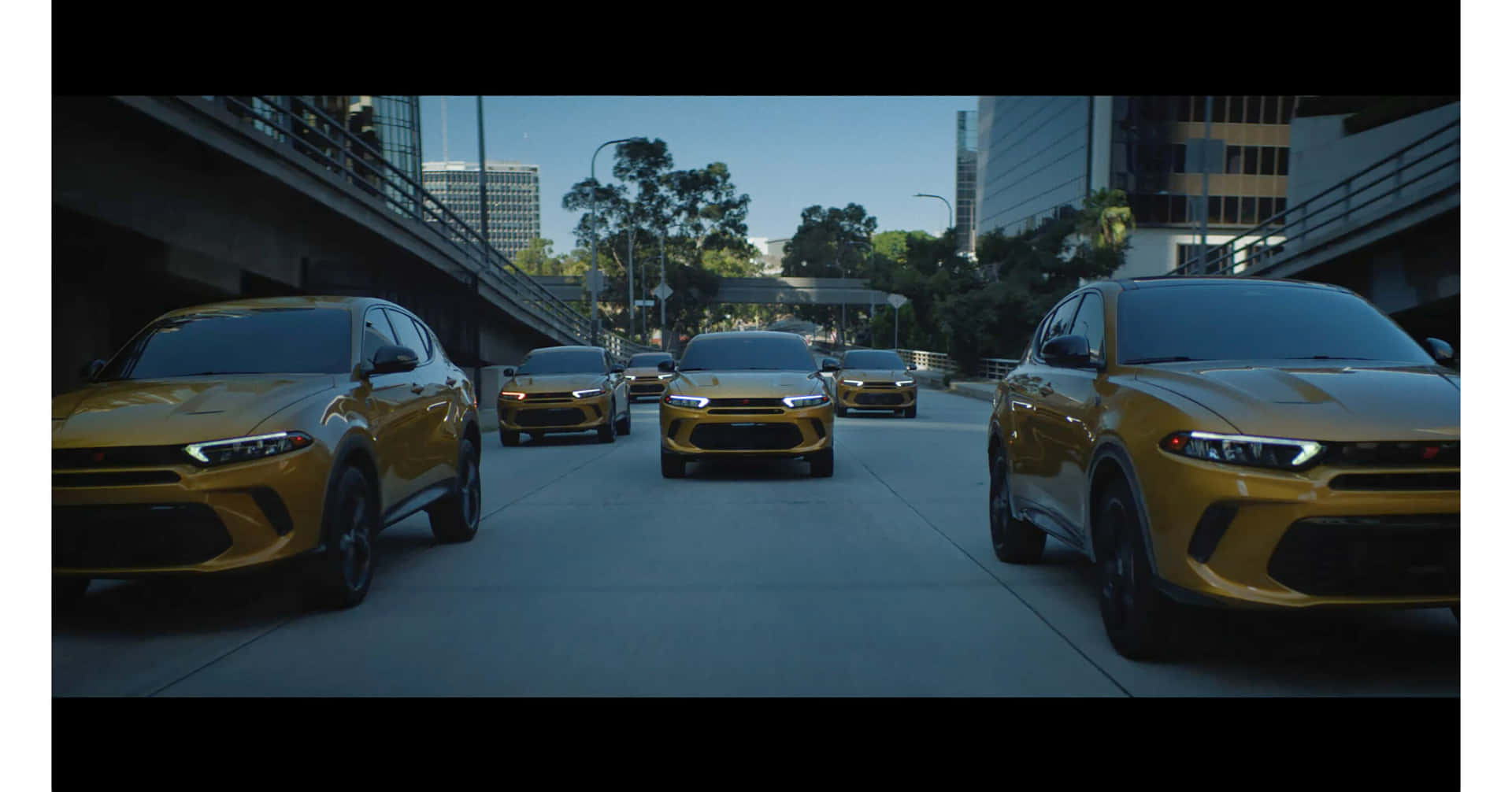 A Group Of Yellow Suvs Are Parked In A City