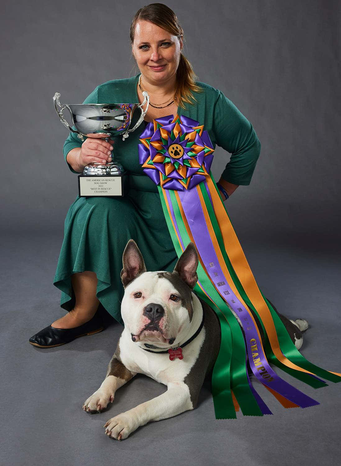 A Woman With A Dog Holding A Ribbon