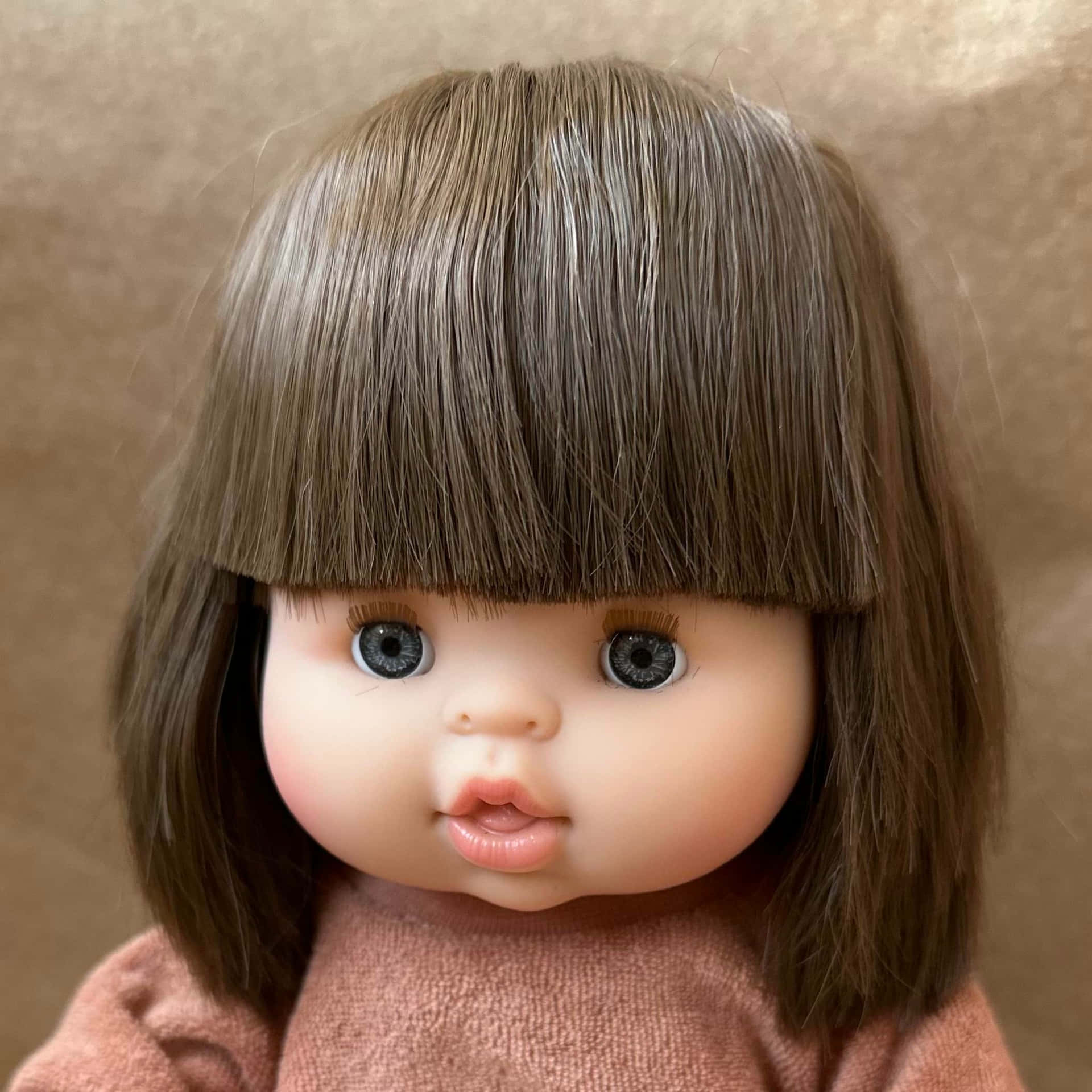 A Doll With Brown Hair And Brown Eyes