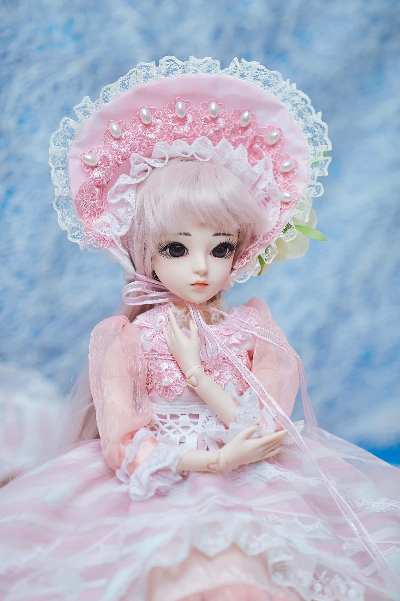 Doll Is Wearing A Pink Dress