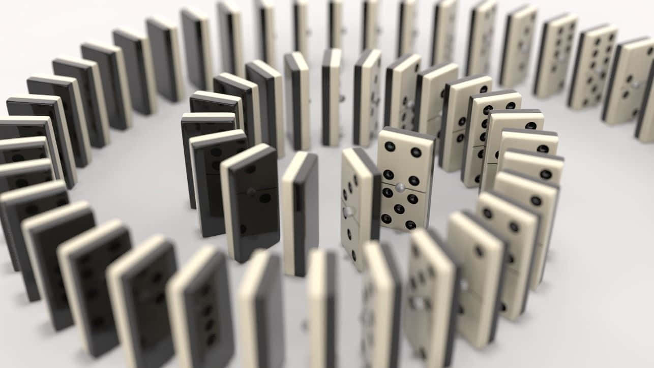 Rows of Falling Dominoes on Wooden Table