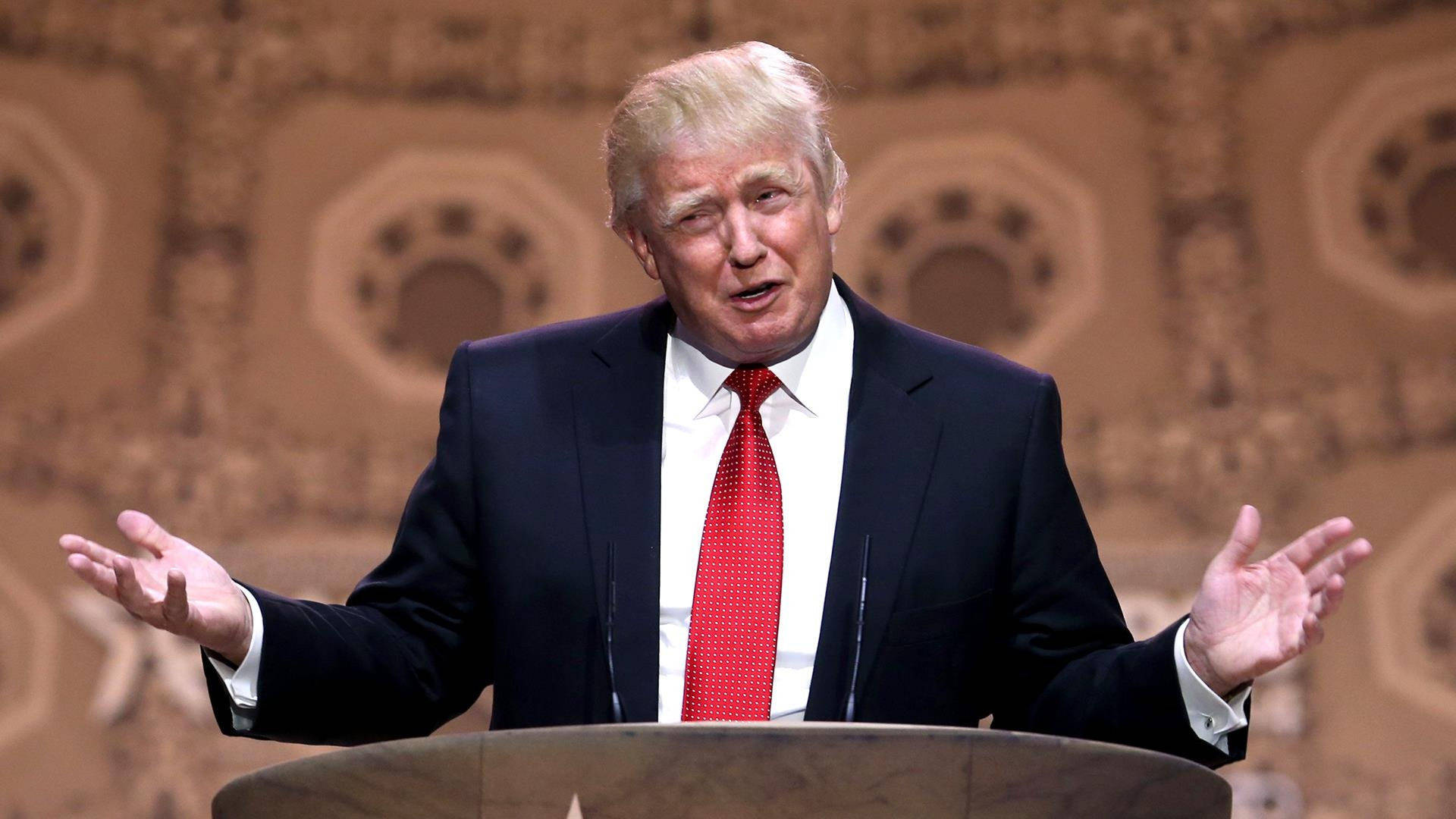 Donald Trump Speaking On A Podium Wallpaper