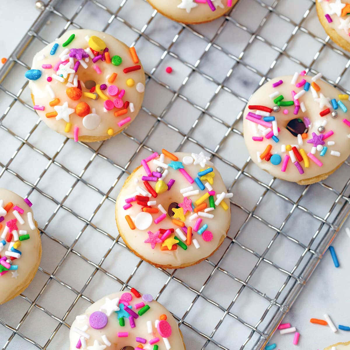 A Rack Of Donuts With Sprinkles