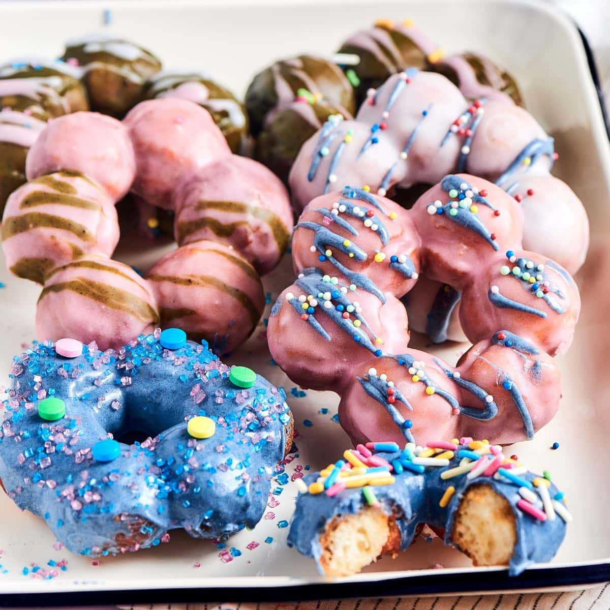 A Tray Of Donuts With Sprinkles