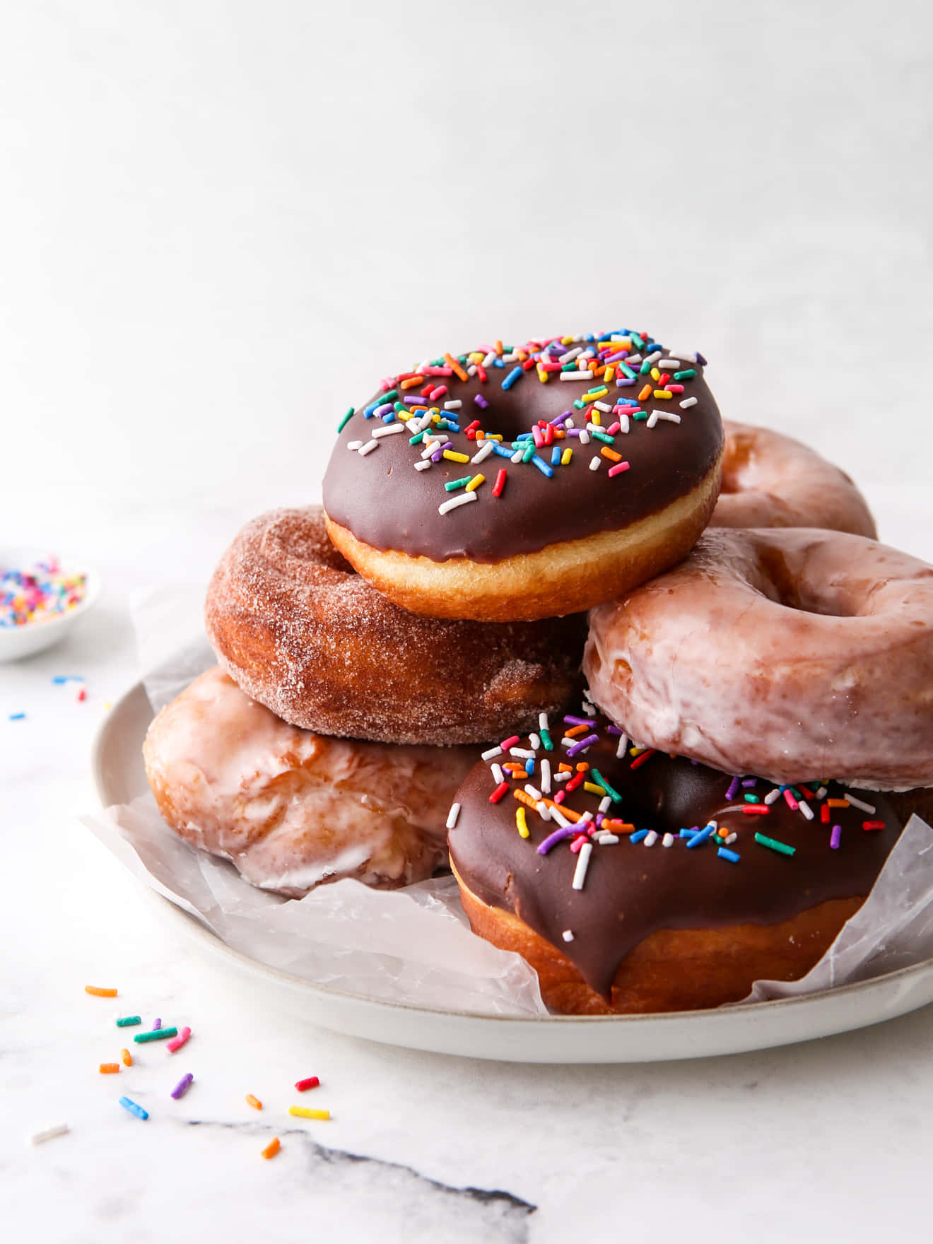Enjoy a delicious classic donut with pink frosting and sprinkles.