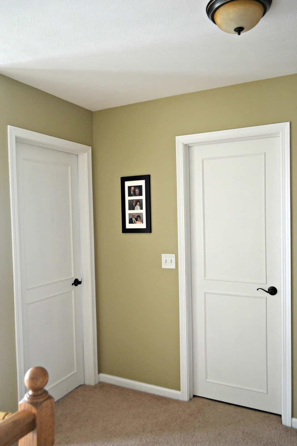 A Room With Two White Doors And A Picture