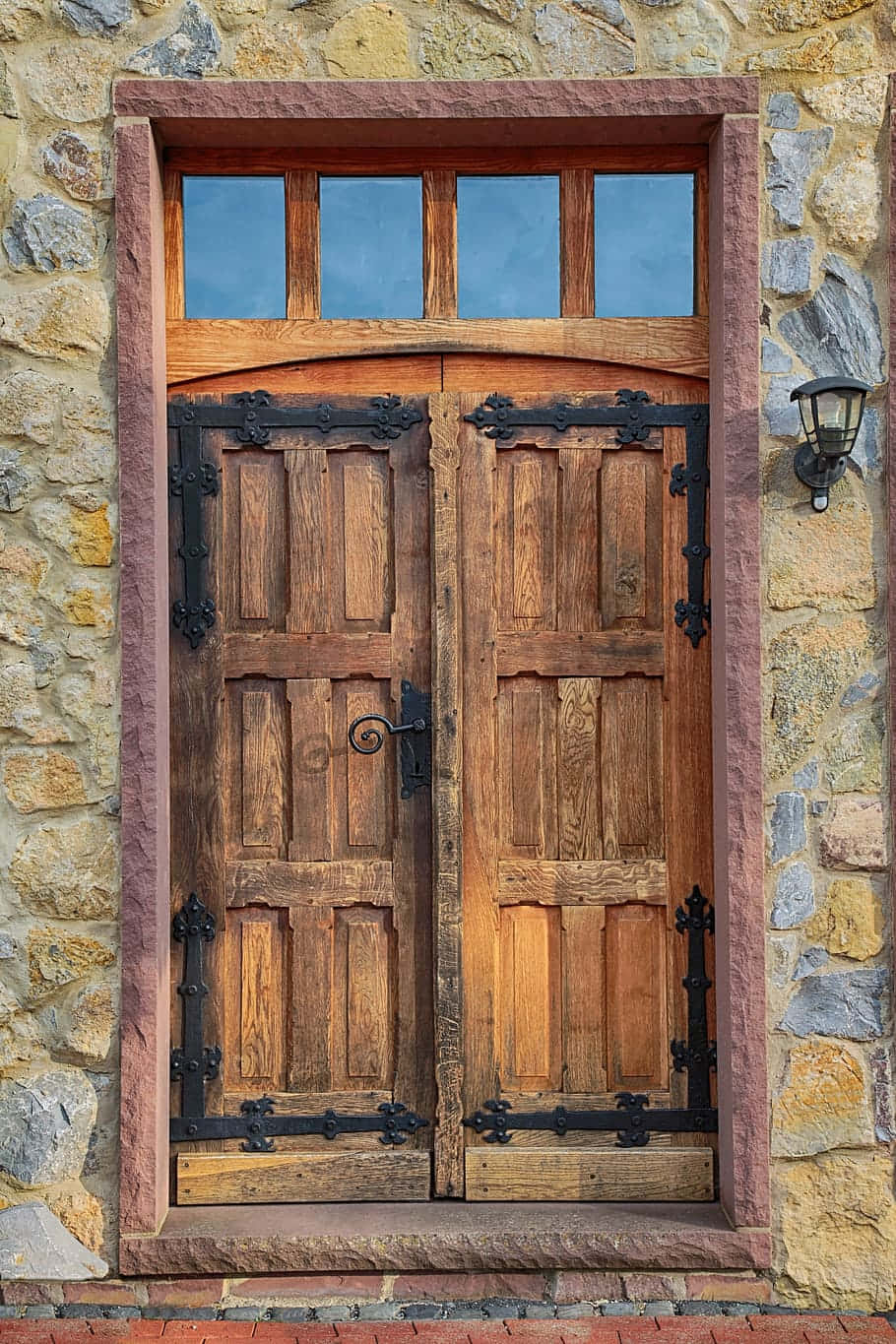 A Wooden Door With A Stone Wall