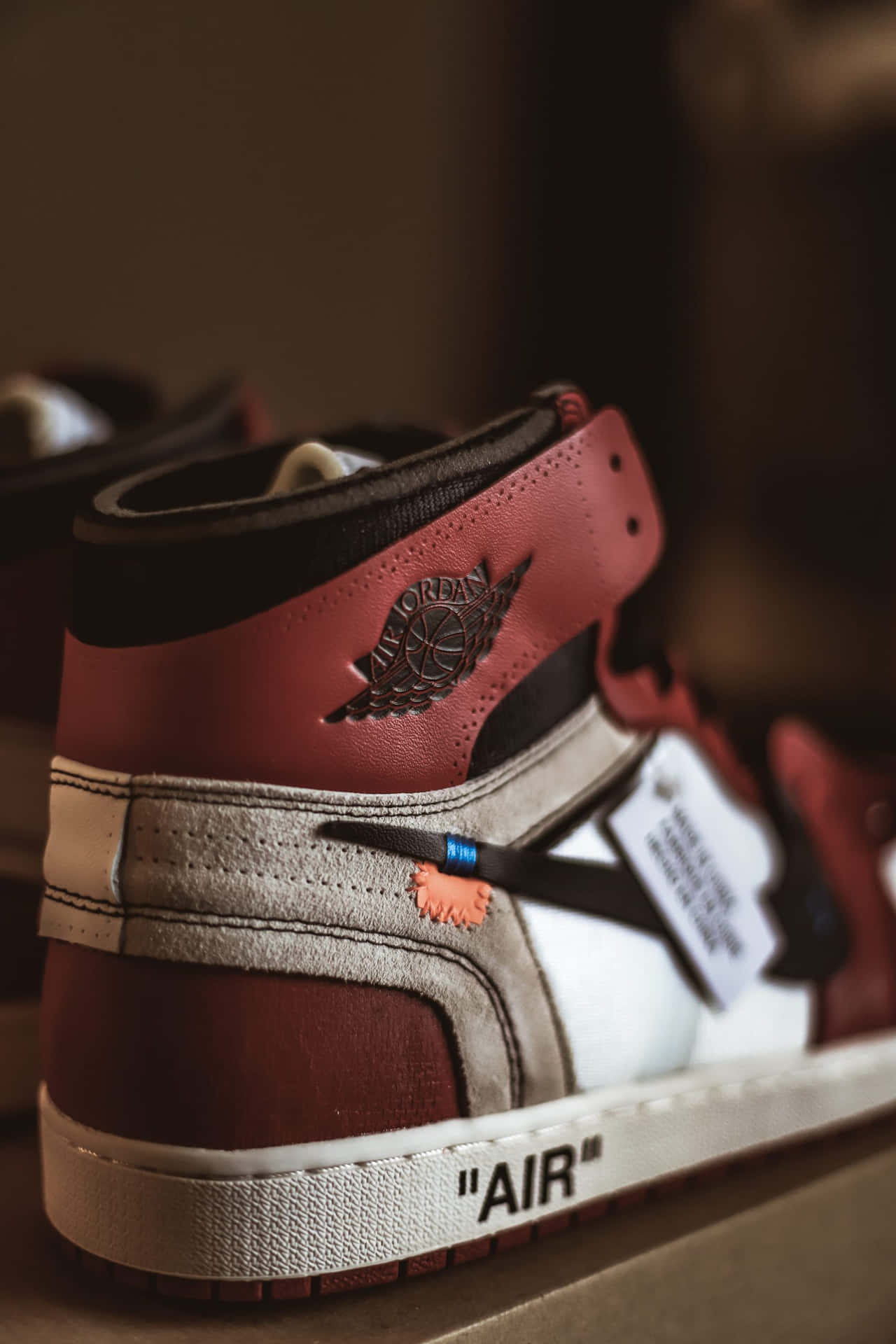 A Pair Of Air Jordan 1's With A Red And White Logo Wallpaper
