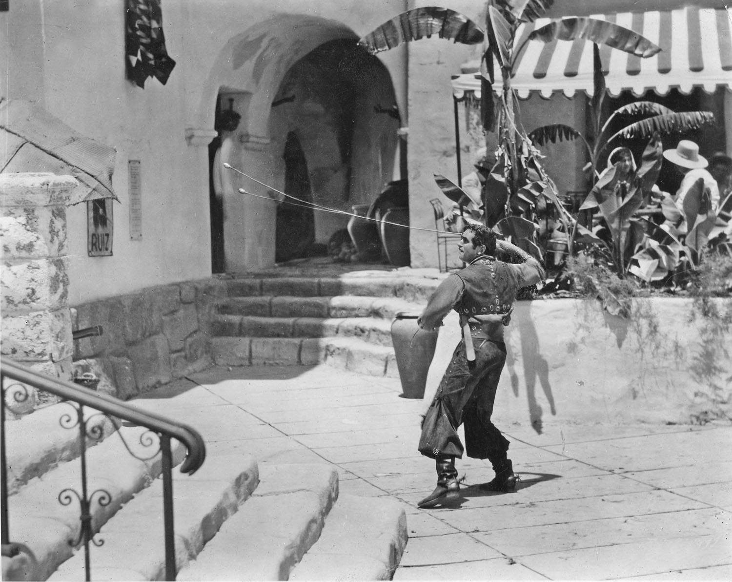 Douglas Fairbanks Posing Elegantly on a Staircase in Black and White Wallpaper