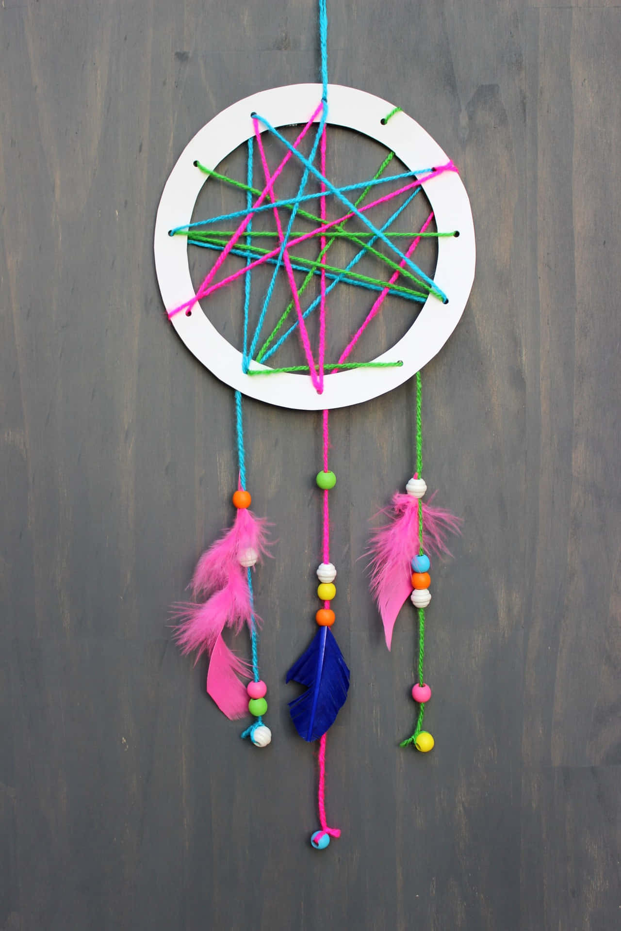 A Colorful Dream Catcher Hanging On A Wall