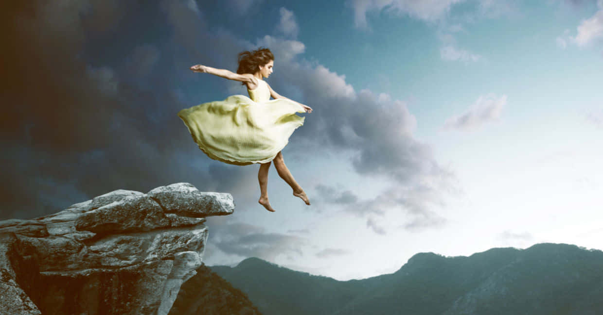 A Woman Is Jumping Off A Cliff