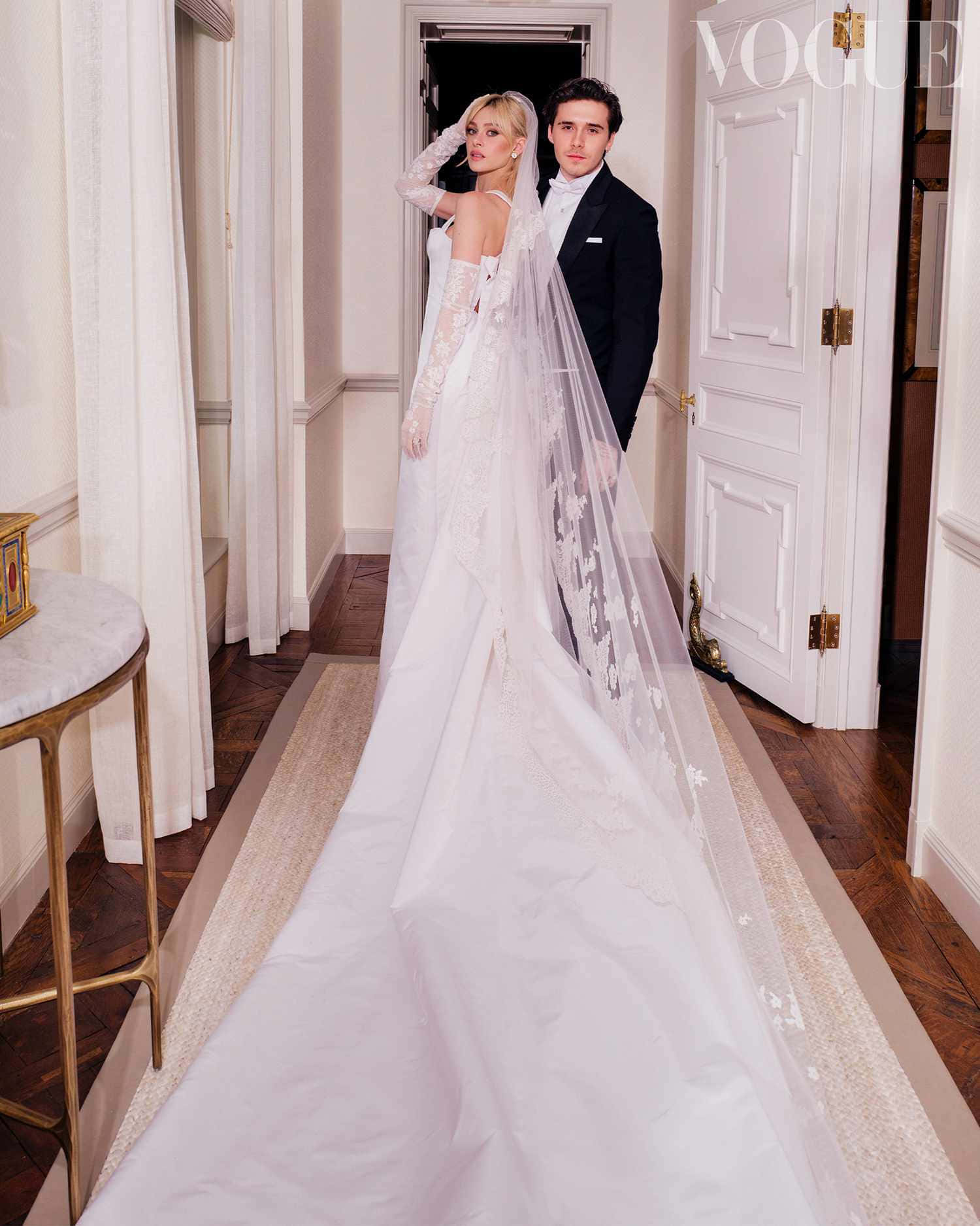 A Bride And Groom Standing In A Hallway