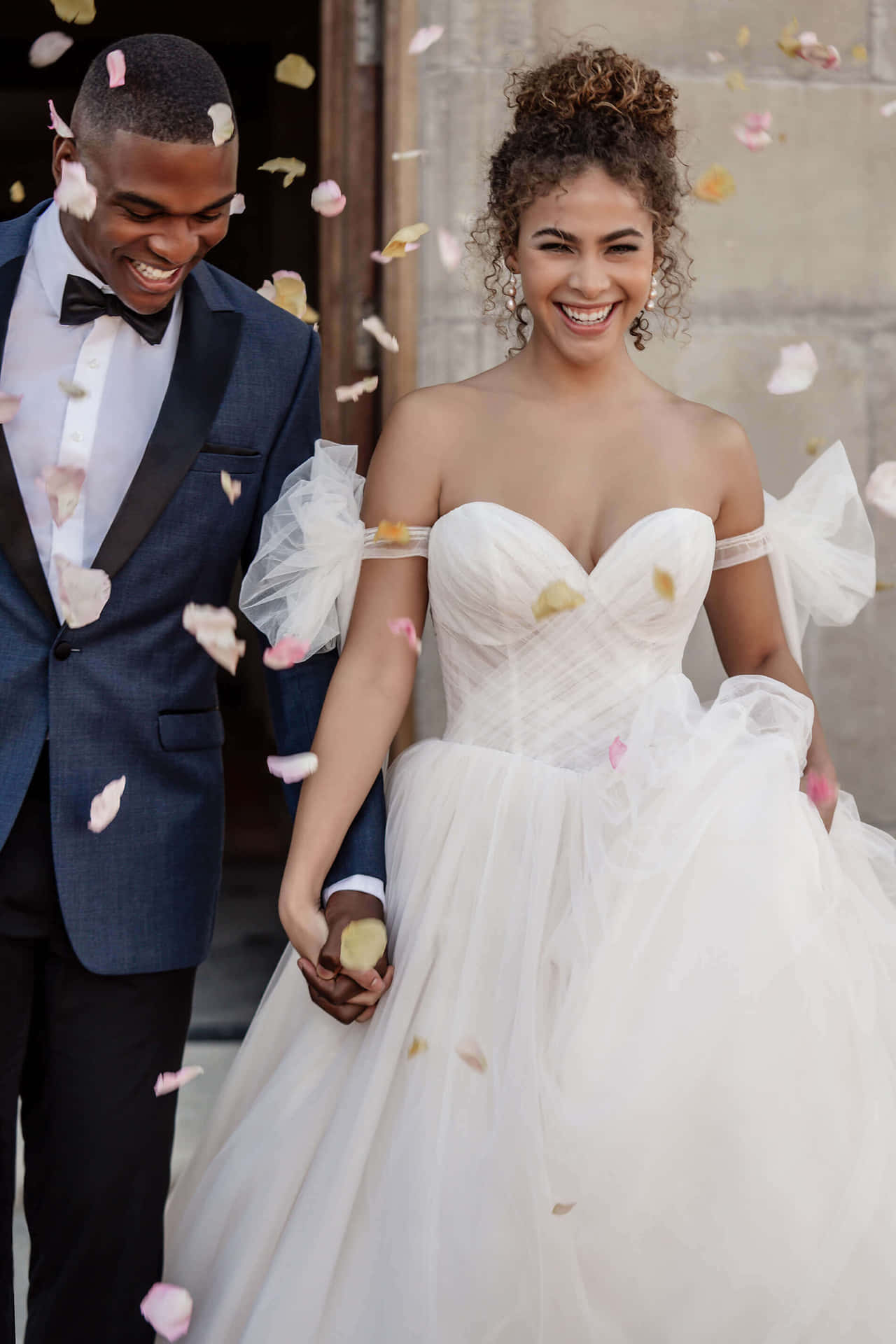 A Bride And Groom Walking Through Confetti