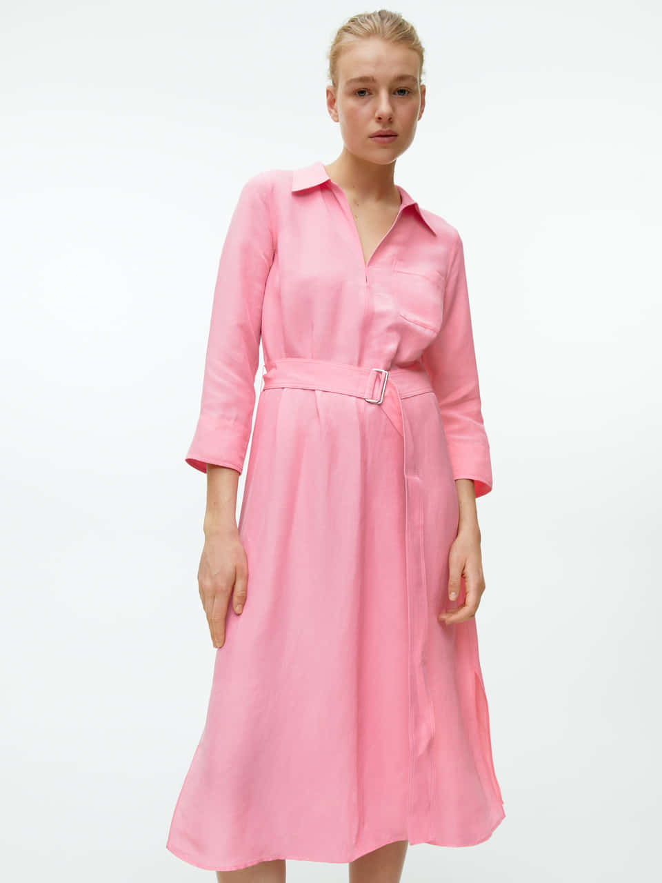 Download A Woman Wearing A Pink Shirt Dress | Wallpapers.com