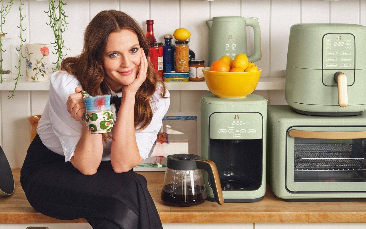 Actress Drew Barrymore in a beautifully designed green kitchen. Wallpaper