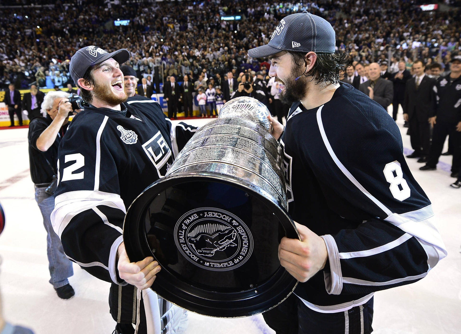 Drew Doughty Holding The Stanley Cup With Team Player Jonathan Quick Wallpaper