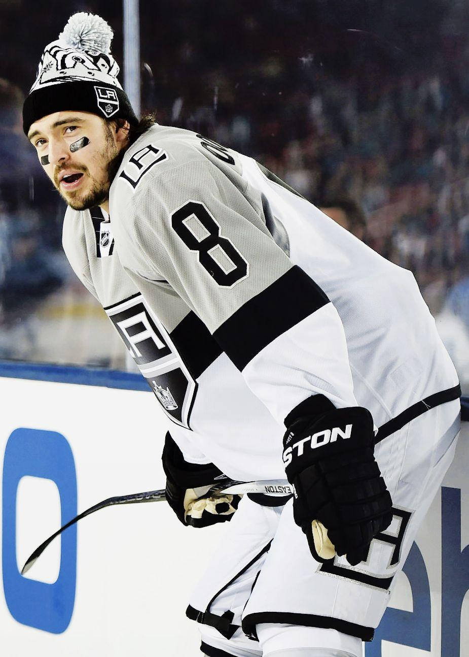 Drew Doughty Leaning Forward While Holding Hockey Stick In Front Wallpaper