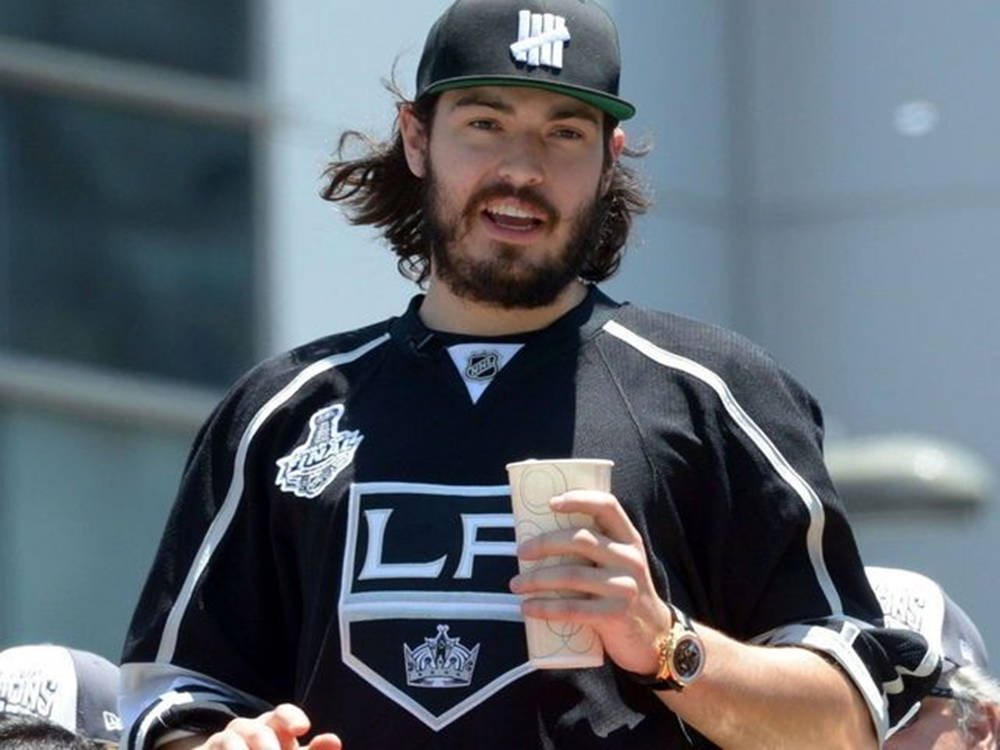 Drew Doughty Wearing Snapback Cap And Holding Large Cup Wallpaper