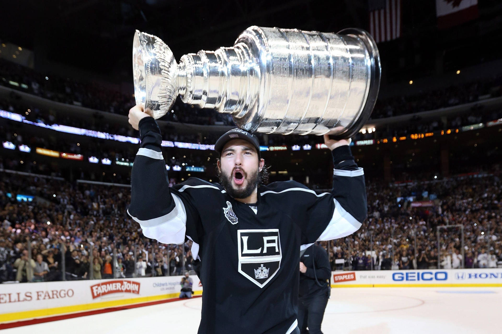 Drew Doughty With Shocked Expression Carrying The Stanley Cup Wallpaper