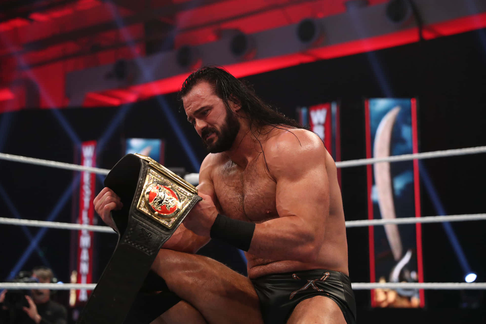 WWE Superstar Drew McIntyre triumphantly holding the RAW Championship Belt. Wallpaper