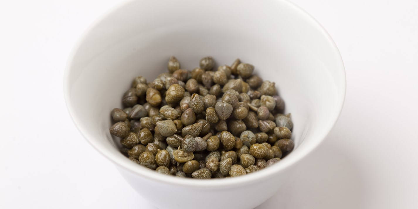 Dried Dark Green Capers In Bowl Wallpaper