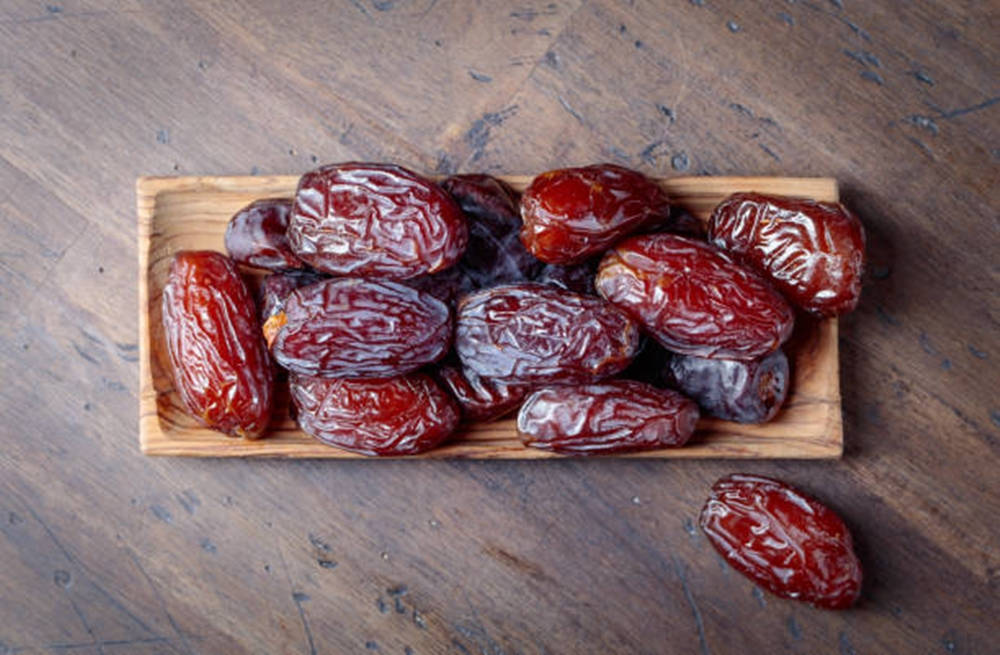 Dried Dates Set On A Wooden Table Wallpaper