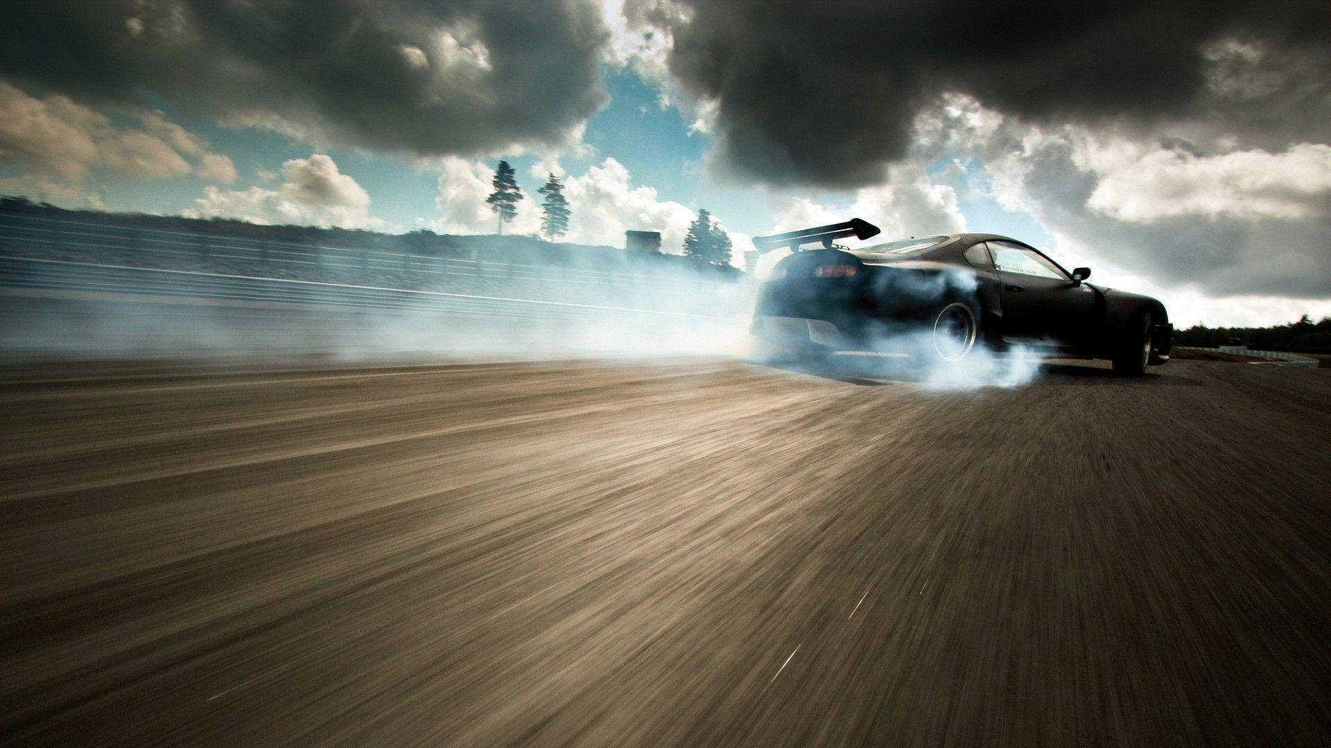 Drift Car Speeding Under Stormy Clouds Wallpaper