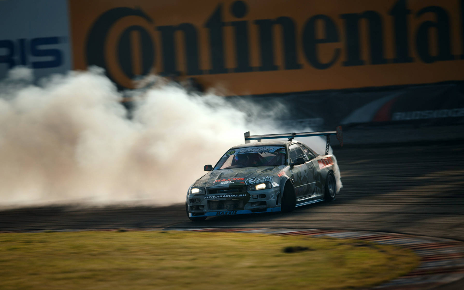 Premium Photo  Aerial view drift battle, two cars drift battle on race  track with smoke.