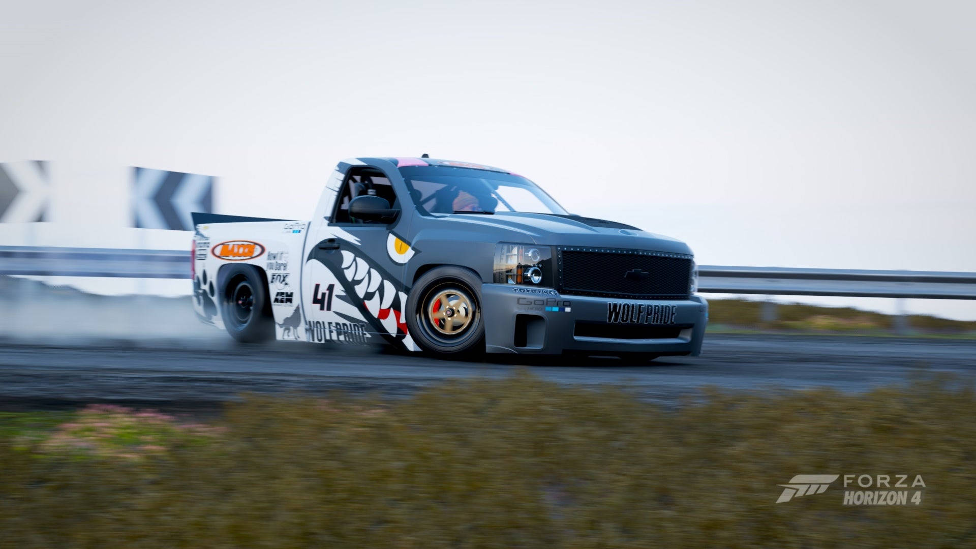 A Truck Driving Down A Track In A Racing Game Wallpaper