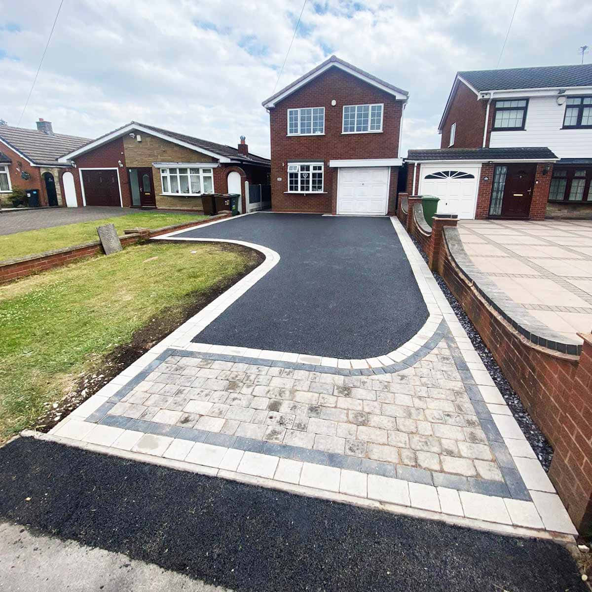 A Driveway With A Black Paved Area