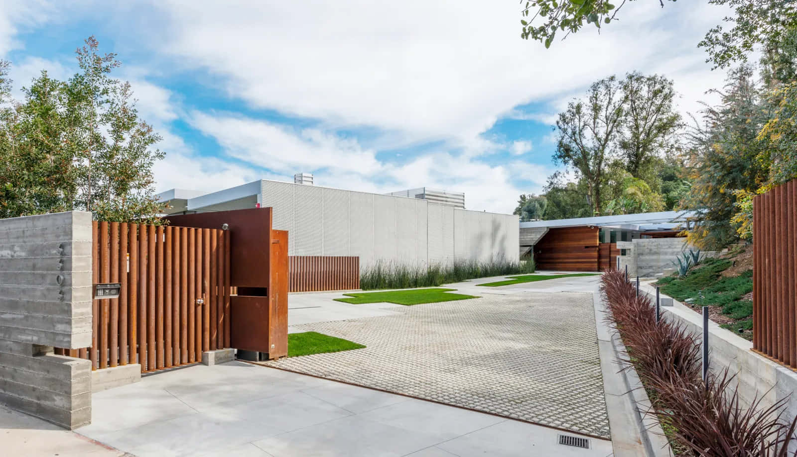A Modern Home With A Wooden Gate And A Wooden Fence